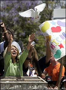 A woman releases doves outside the courthouse