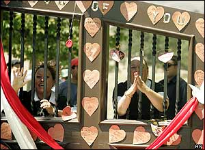 Staff at the Neverland ranch wave to fans