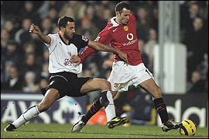 Ryan Giggs holds off Sylvain Legwinski