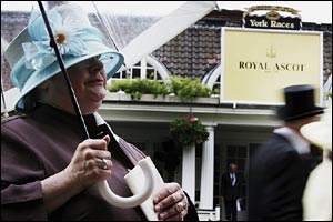A woman shelters under an umbrella