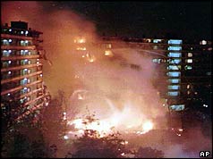 Tower blocks at night with smoke and fire