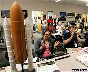 Nasa employees clap as space shuttle Discovery touches down 