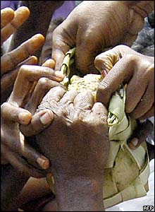 Survivors grab hold of a food parcel in Nagapattinam, India
