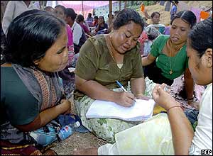 Villagers make up lists of the missing at a refugee camp in Port Blair, Andaman Islands