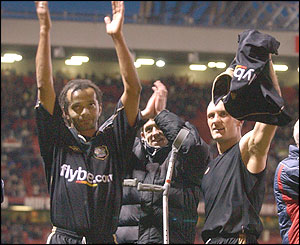 Exeter City players Les Afful and Sean Devine celebrate