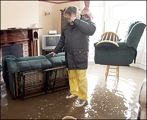 Ian Curry examines the flood damage to his Warwick Road home