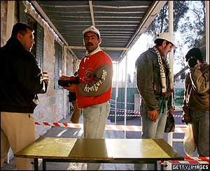 Palestinians line up to cast their ballots at the start of voting at a polling station in Hawarra, West Bank