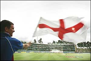 An England fan waves his flag as the team take command on the fifth day
