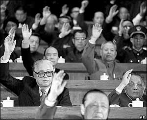 Chinese Communist Party General Secretary Zhao Ziyang (left in 2nd row) and Chinese leader Deng Xiaoping (right in 2nd row) vote at the start of the National People's Congress in Beijing, March 1988