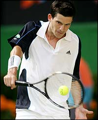 Tim Henman hits a backhand winner