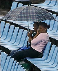 Two fans brave the rain