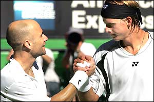 Andre Agassi and Joachim Johansson at the net