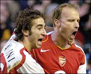Dennis Bergkamp celebrates his goal with Mathieu Flamini