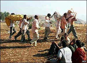 Bodies are carried away from the temple