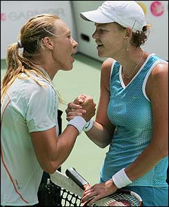 Alicia Molik (left) and Lindsay Davenport embrace at the net as the American progresses