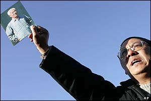 A protester holds up a picture of Zhao Ziyang outside Babaoshan cemetery 