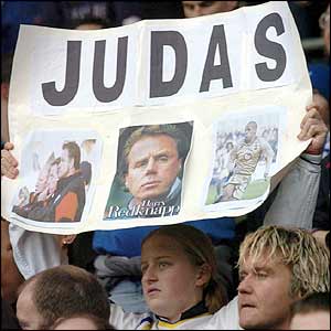 A Portsmouth fans holds a banner condemning Harry Redknapp