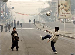 Boys play on the street in Baghdad
