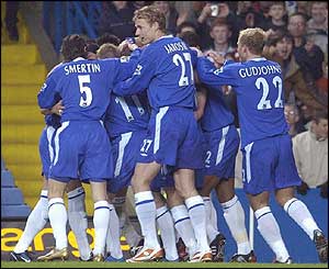 Chelsea's Robert Huth is mobbed by his team-mates after scoring the opening goal of the game