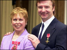 Torvill and Dean in 1999 with their OBEs