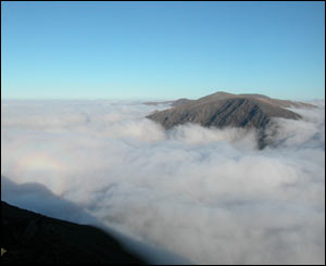 Clouds surrounding the summit of Y Garn in Snowdonia with a view over to Pen Yr Ole Wen and Carnedd Dafydd