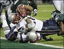 Patriots running back Corey Dillon lunges backwards for his touchdown