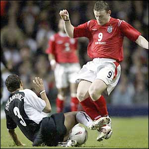 Wayne Rooney is tackled by Khalid Boulahrouz