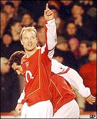 Dennis Bergkamp signals to the crowd as he puts Arsenal ahead