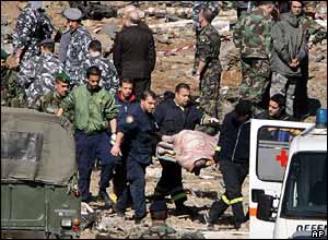 Rescue workers recover a body from rubble near the blast site