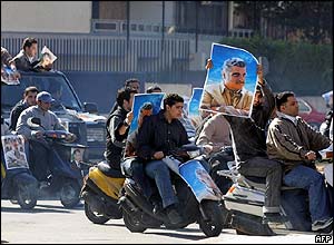 Hariri supporters drive around Beirut with posters of the late former prime minister