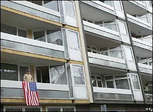 A US supporter stands by a US flag in Mainz, Germany