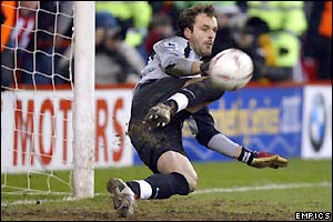 Manuel Almunia saves two penalties in the shoot-out as Arsenal book a trip to Bolton in the next round 