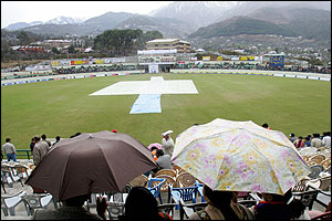 Despite the rain, spectators can still see the Himalayan foothills in the distance
