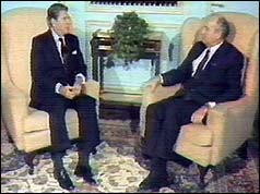 Reagan and Gorbachev facing each other in two armchairs