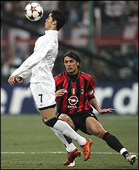 Ronaldo heads the ball away from Paolo Maldini 