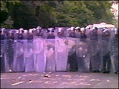 Police officers holding riot shields
