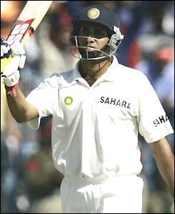 VVS Laxman raises his bat to celebrate his 21st Test half-century 