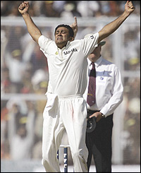 Indian cricketer Anil Kumble raises his hands in celebration