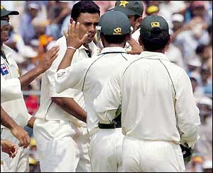Danish Kaneria celebrates with team-mates as he claims the lbw of Gautam Gambhir for 29