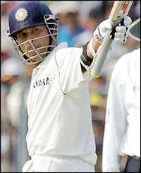 Sachin Tendulkar salutes the crowd after clocking up his 10,000th Test run