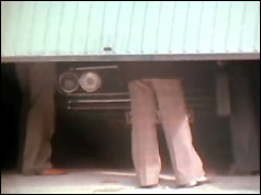 Half-open garage door with part of car visible