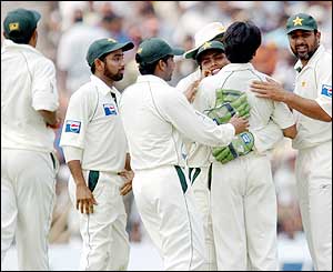 The Pakistan team celebrate the wicket of Virender Sehwag as they begin to fight back