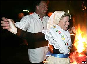 A couple in traditional clothes dance around an Easter fire 27 March 2005 in Luebbenau, eastern Germany