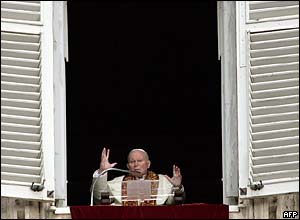 Pope John Paul II blesses the crowds at the Vatican from his window