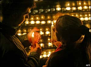 A Romanian couple hold the Holy Light in Bucharest