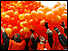 Protestors releasing orange balloons (copyright: AFP)