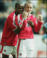 Kevin Lisbie congratulates Chris Perry on his first goal of the season