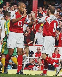 Thierry Henry celebrates with fellow scorer Freddie Ljungberg