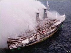 Smoke pouring from ship, damage to side