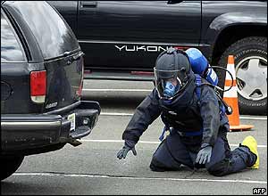 An officer prepared to look under a suspect vehicle